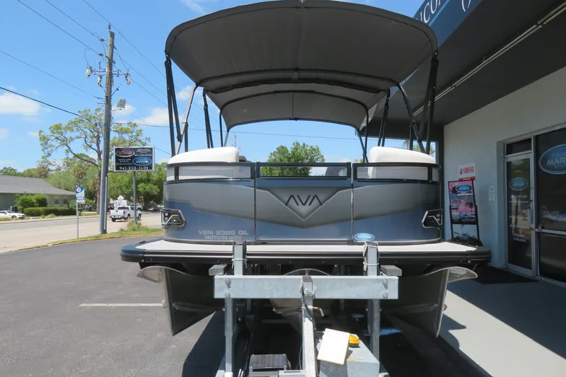Slide: The Image of 2026 Avalon Venture 85 Quad Lounge pontoon boat on trailer, parked outside dealership. - 2