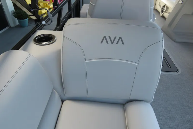 Slide: The Image of 2026 Avalon Venture 85 Quad Lounge interior with sleek white seating and integrated cup holder. - 24