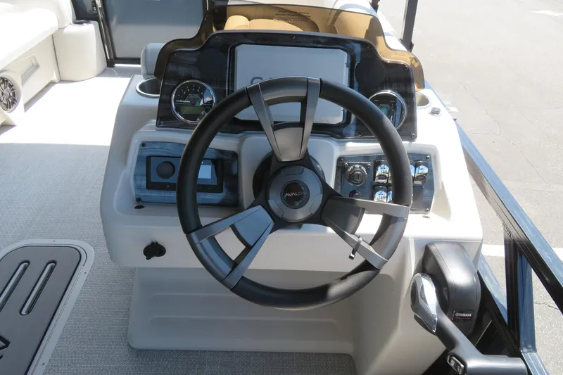 Slide: The Image of Steering console of 2026 Avalon Venture 85 Quad Lounge boat, featuring modern controls and dashboard. - 28