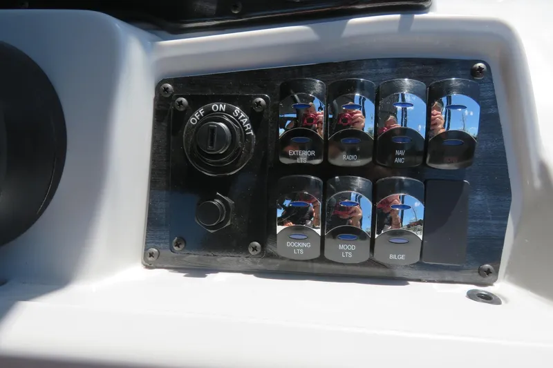 Slide: The Image of Control panel of 2026 Avalon Venture 85 Quad Lounge boat with labeled switches. - 49