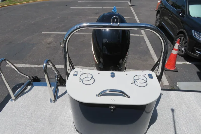 Slide: The Image of 2026 Avalon Venture 85 Quad Lounge boat rear view in parking lot. - 53