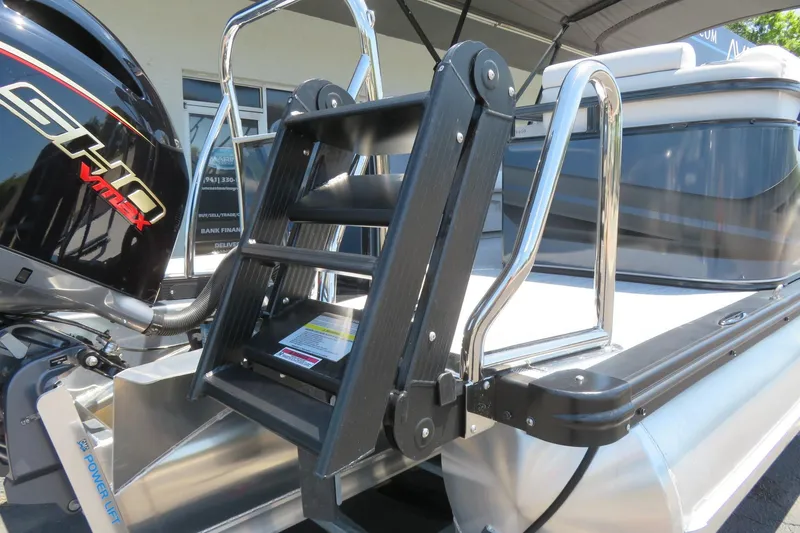 Slide: The Image of 2026 Avalon Venture 85 Quad Lounge boat with ladder and powerful outboard motor. - 8