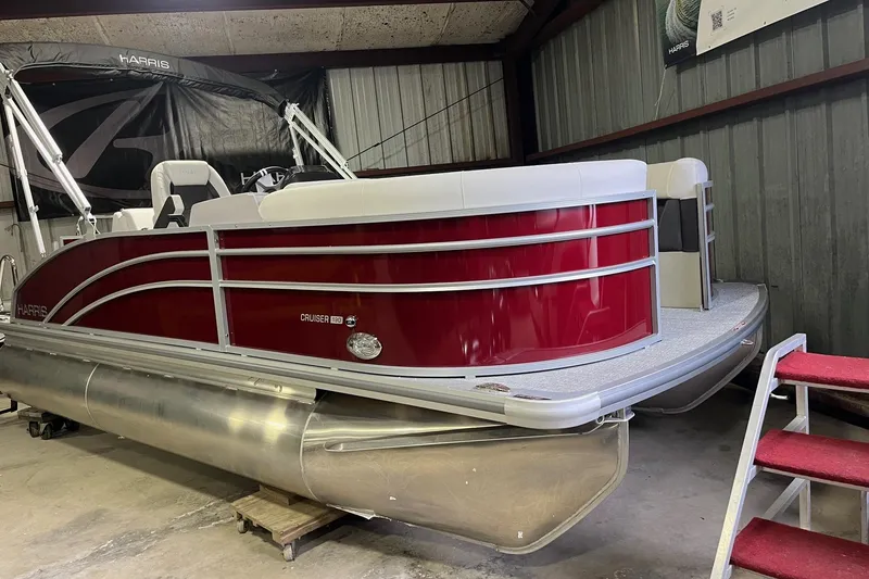 Slide: The Image of 2026 Harris Cruiser 190 CS pontoon boat in a garage, featuring a sleek red design. - 3