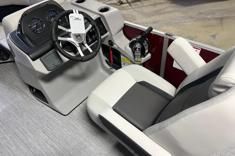 Slide: The Image of Interior of 2026 Harris Cruiser 190 CS boat with steering wheel and captain's chair. - 5