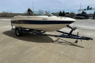 The Image of 2004 Chaparral 190 SSi boat on trailer, parked outside a building. - 0
