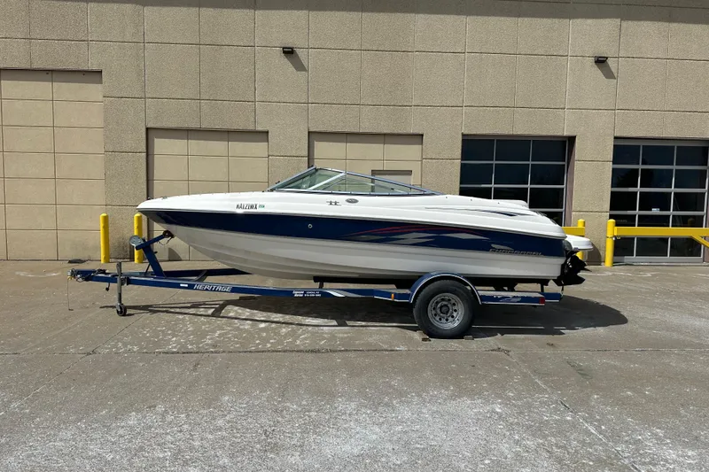 Slide: The Image of 2004 Chaparral 190 SSi boat parked outdoors on a sunny day. - 3