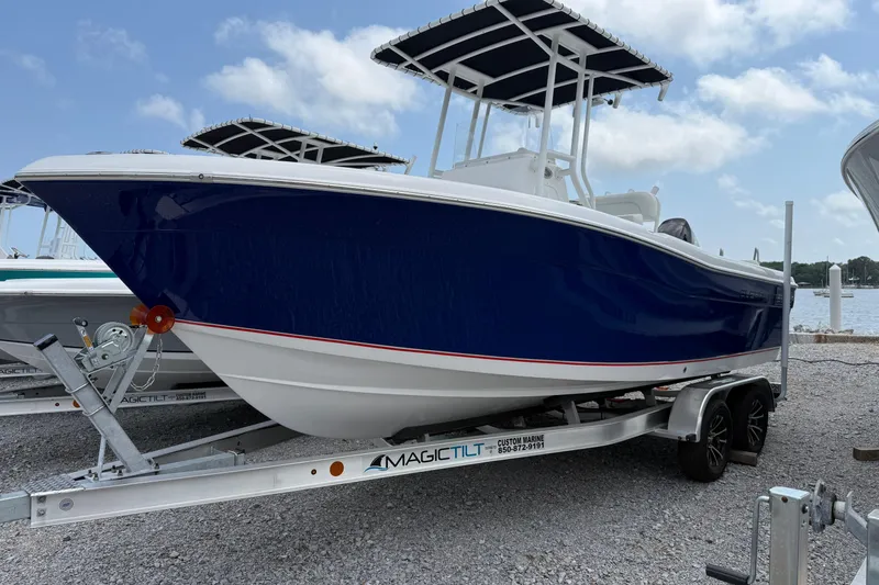 The Image of 2026 Clearwater 2200 Center Console boat on trailer by the water. - 0