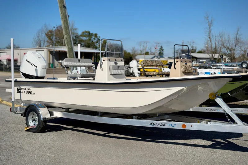 The Image of 2026 Carolina Skiff E20 JVX CC boat on trailer, featuring Honda engine. - 1