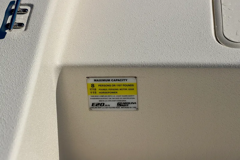 Slide: The Image of 2026 Carolina Skiff E20 JVX CC capacity label, showing maximum weight and horsepower limits. - 8