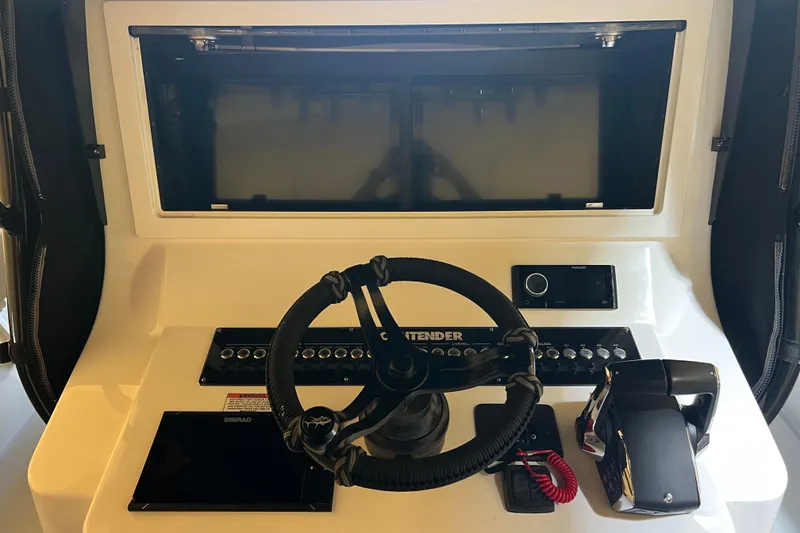 Slide: The Image of 2018 Contender 39 ST boat dashboard with steering wheel and control panel. - 12
