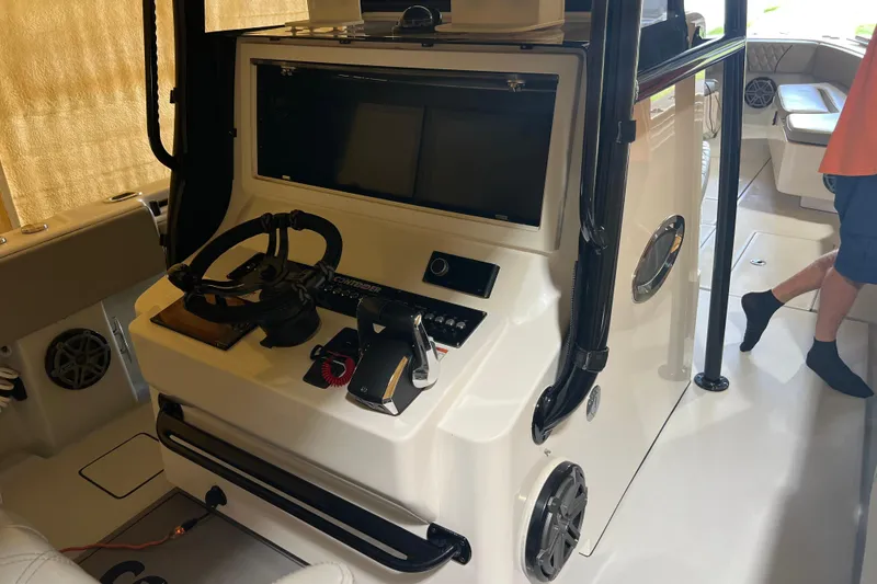 Slide: The Image of 2018 Contender 39 ST boat helm with steering wheel and control panel. - 21