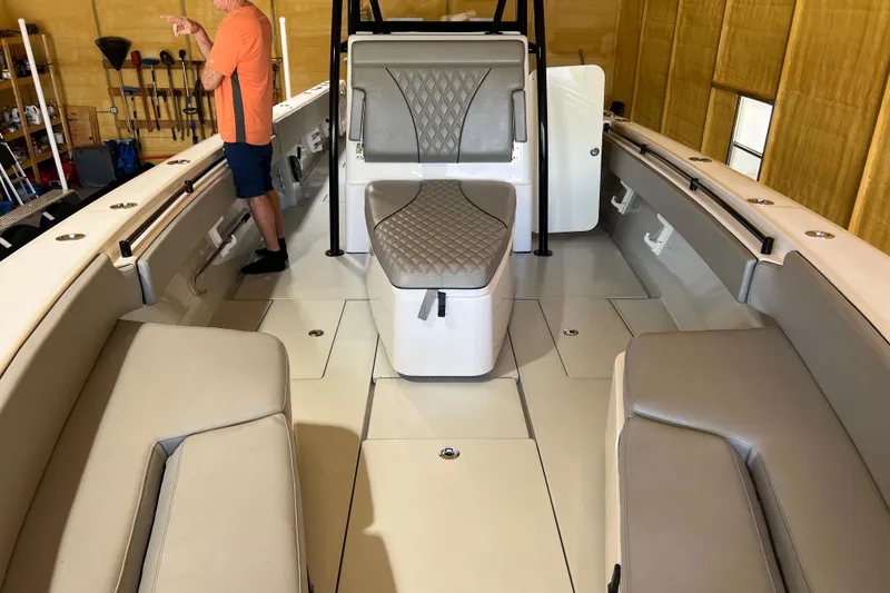 Slide: The Image of 2018 Contender 39 ST boat interior with seating and storage in a garage setting. - 27