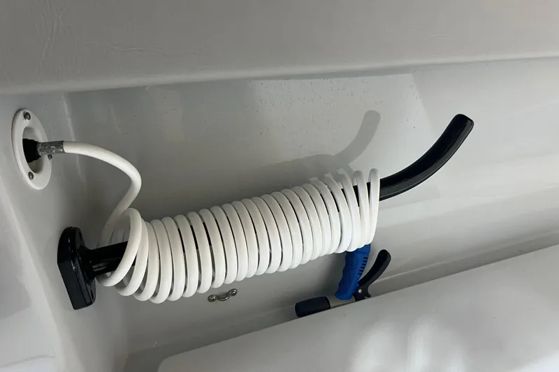 Slide: The Image of Coiled white hose with nozzle in 2018 Contender 39 ST boat. - 29
