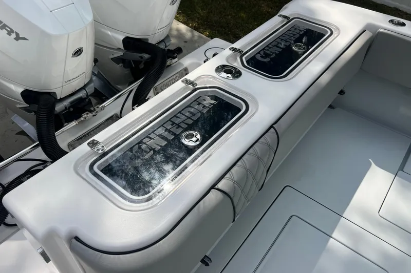Slide: The Image of 2018 Contender 39 ST boat deck with storage compartments and Mercury engines. - 30