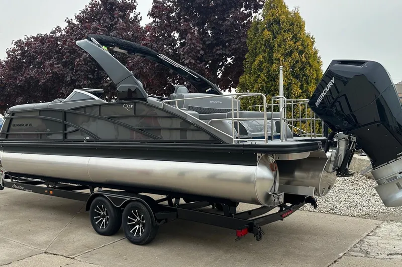 Slide: The Image of 2024 Bennington 25 QSBWA pontoon boat on trailer, featuring Mercury outboard engine. - 17