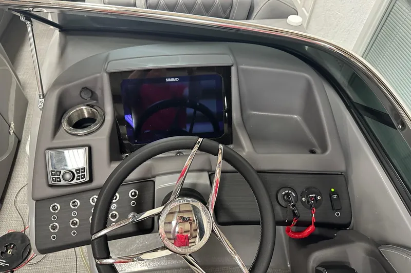 Slide: The Image of 2024 Bennington 25 QSBWA boat dashboard with steering wheel and control panel. - 22