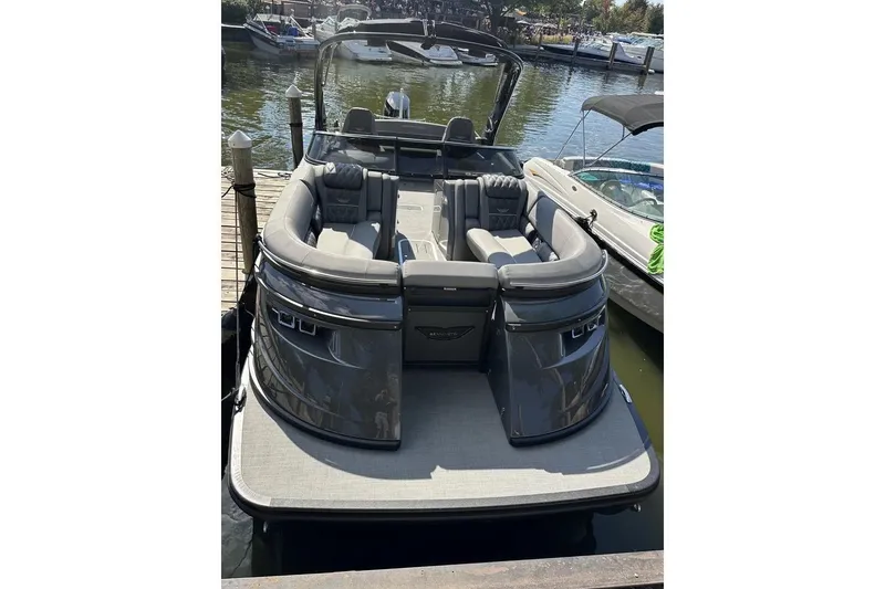Slide: The Image of 2024 Bennington 25 QSBWA pontoon boat docked, featuring sleek design and spacious seating. - 25