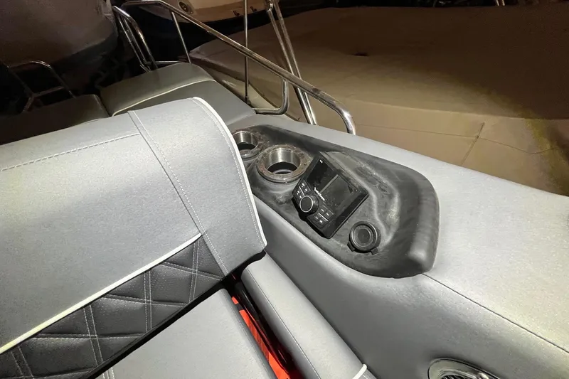 Slide: The Image of 2024 Bennington 25 QSBWA boat interior with control panel and cup holders. - 29