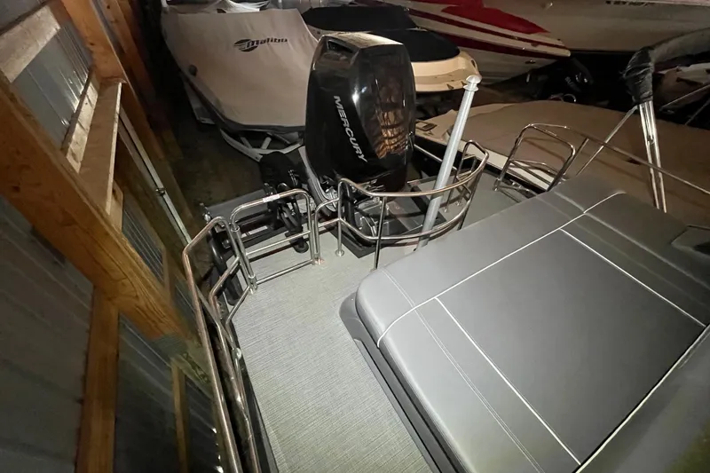 Slide: The Image of 2024 Bennington 25 QSBWA pontoon boat with Mercury engine in storage. - 31