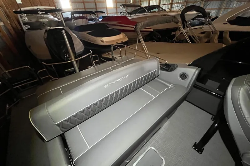 Slide: The Image of 2024 Bennington 25 QSBWA pontoon boat interior with gray seating in storage. - 32