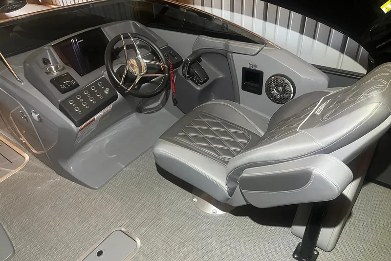 Slide: The Image of 2024 Bennington 25 QSBWA boat interior with modern helm and luxurious seating. - 39