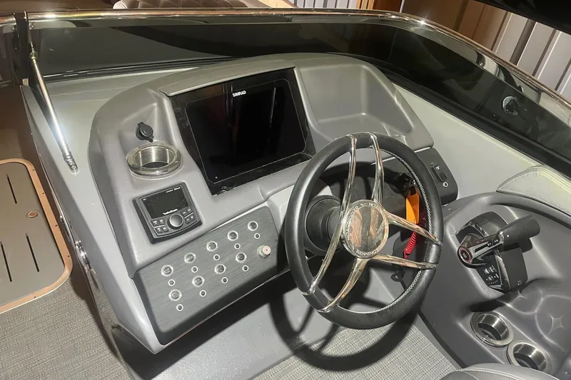 Slide: The Image of 2024 Bennington 25 QSBWA boat dashboard with steering wheel and control panel. - 40