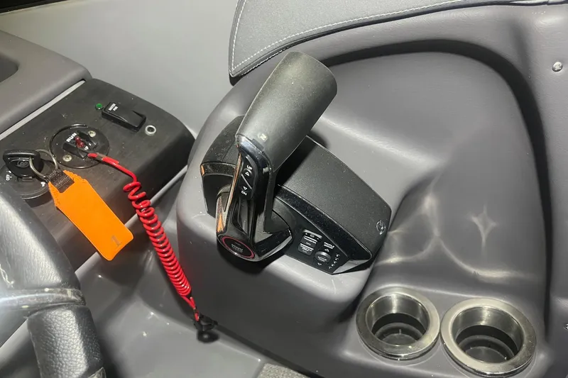 Slide: The Image of Control panel of 2024 Bennington 25 QSBWA boat with throttle and cup holders. - 41