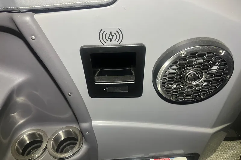 Slide: The Image of 2024 Bennington 25 QSBWA interior with speaker, wireless charging, and cup holders. - 42