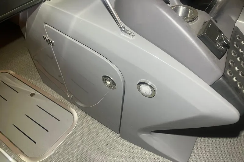 Slide: The Image of 2024 Bennington 25 QSBWA boat interior console with storage and control panel. - 48