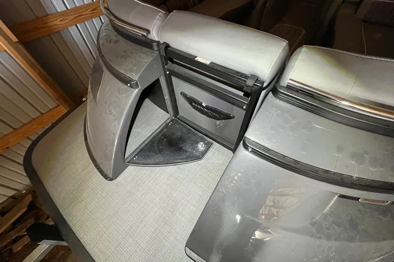 Slide: The Image of 2024 Bennington 25 QSBWA boat interior with storage compartment and seating. - 54
