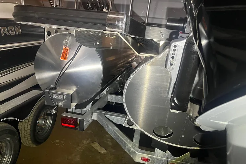 Slide: The Image of 2024 Bennington 25 QSBWA pontoon boat on trailer, close-up view. - 57