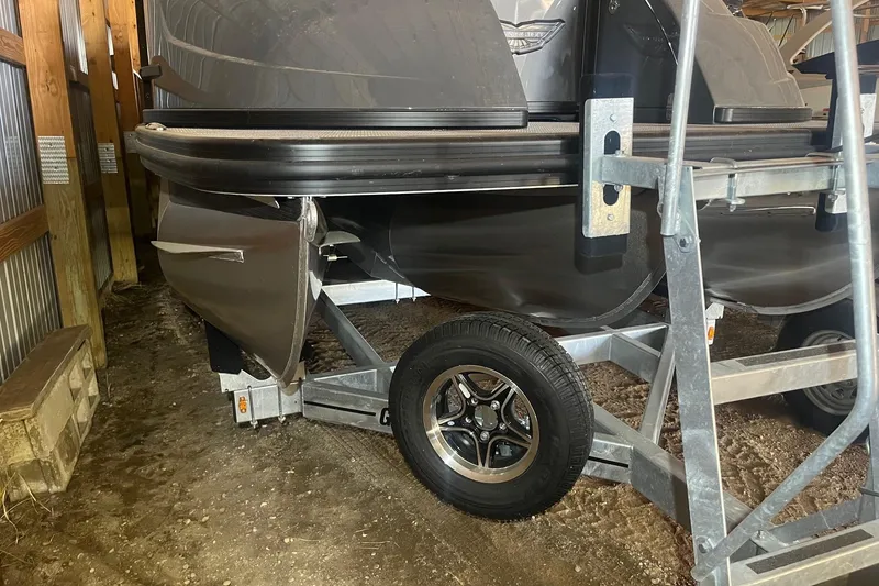 Slide: The Image of 2024 Bennington 25 QSBWA pontoon boat on trailer in storage shed. - 60