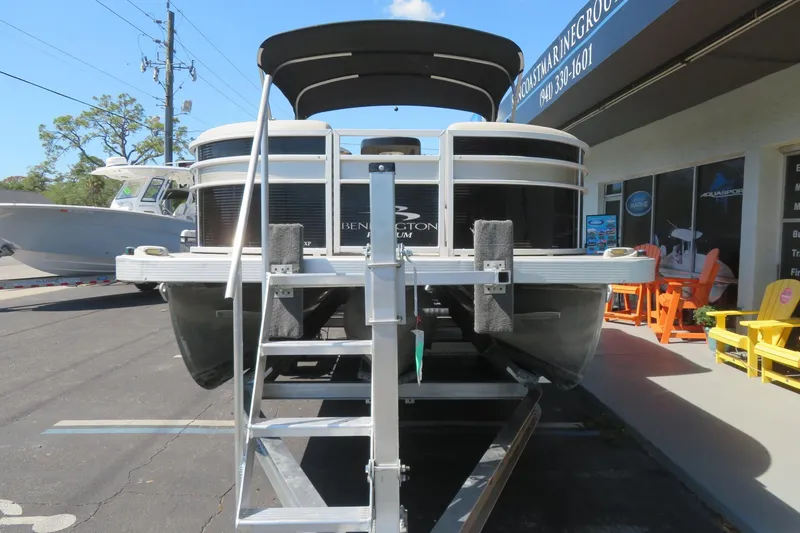 Slide: The Image of 2018 Bennington 23 SSRXP pontoon boat on trailer outside marine dealership. - 16