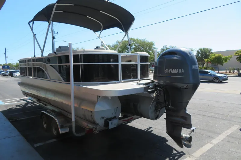 Slide: The Image of 2018 Bennington 23 SSRXP pontoon boat with Yamaha outboard motor on trailer. - 19