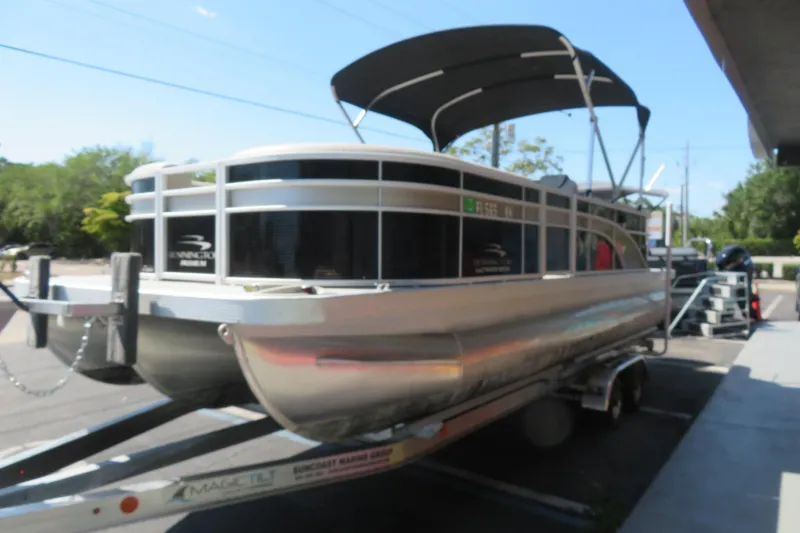 Slide: The Image of 2018 Bennington 23 SSRXP pontoon boat on trailer, parked outdoors. - 20