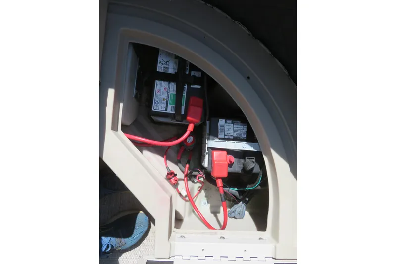 Slide: The Image of Battery compartment of a 2018 Bennington 23 SSRXP pontoon boat with visible wiring. - 36