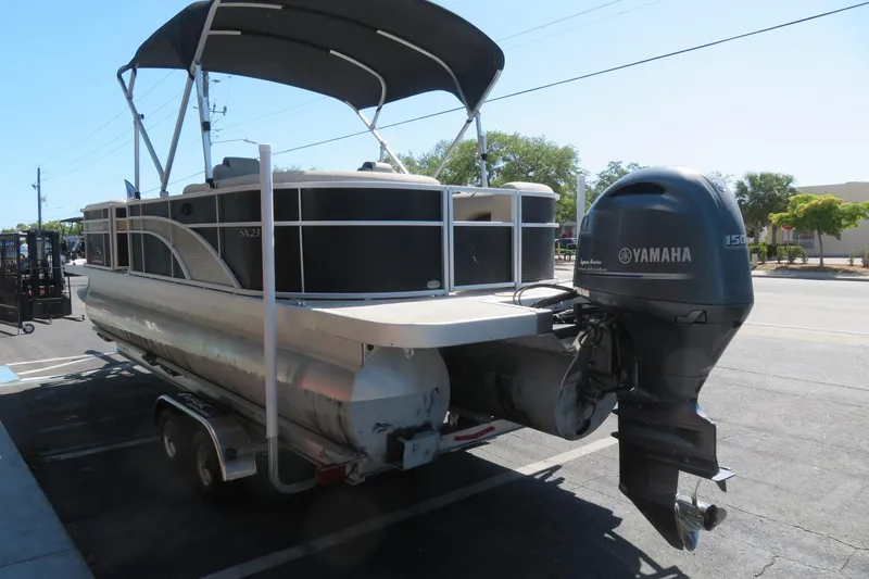 Slide: The Image of 2018 Bennington 23 SSRXP pontoon boat with Yamaha outboard motor on trailer. - 5