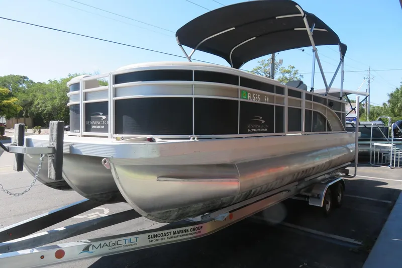 Slide: The Image of 2018 Bennington 23 SSRXP pontoon boat on trailer, featuring sleek design and canopy. - 6