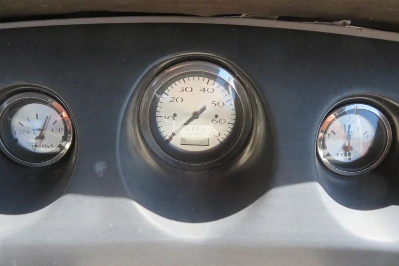 Slide: The Image of Dashboard gauges of a 2018 Bennington 23 SSRXP boat, showing RPM, trim, and fuel levels. - 9