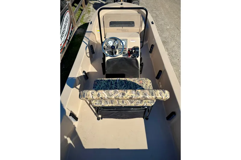 Slide: The Image of 2025 Carolina Skiff E20 JVX CC SPORTSMAN EDITION boat interior with steering console and camo seat. - 11