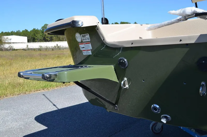 Slide: The Image of Manufacturer Provided Image: 2026 Carolina Skiff E20 JVX CC boat rear view with ladder and green hull. - 21