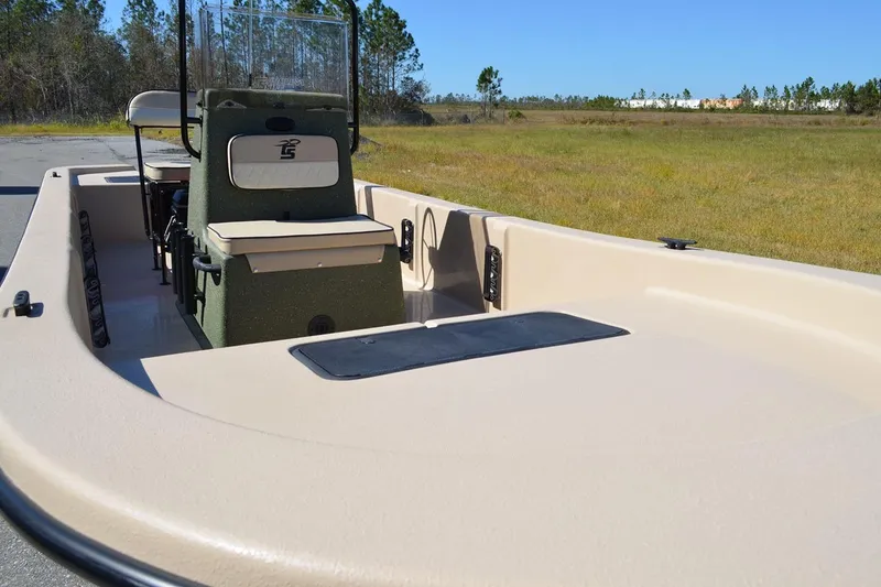 Slide: The Image of Manufacturer Provided Image: 2026 Carolina Skiff E20 JVX CC boat on grassy field, showcasing interior seating and console. - 24