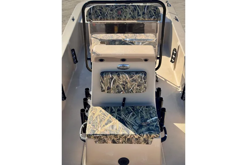 Slide: The Image of 2025 Carolina Skiff E20 JVX CC SPORTSMAN EDITION interior with camouflage seating and rod holders. - 9