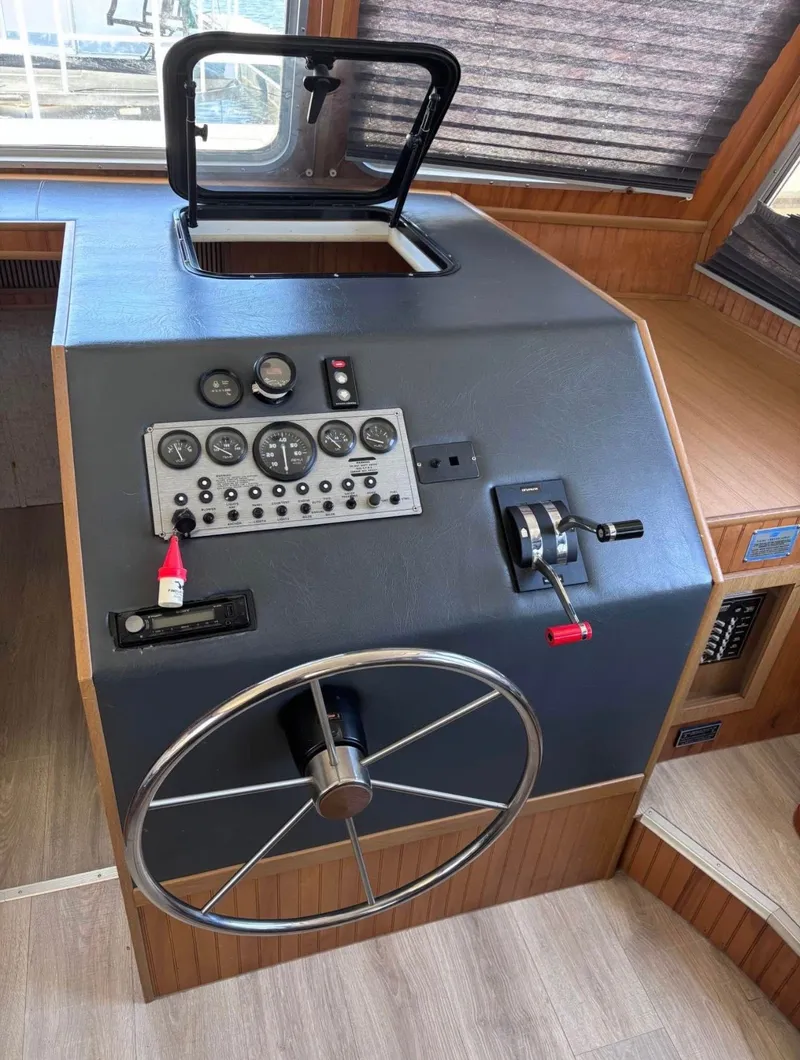 Slide: The Image of 1992 Gibson Sport boat helm with steering wheel and control panel. - 2