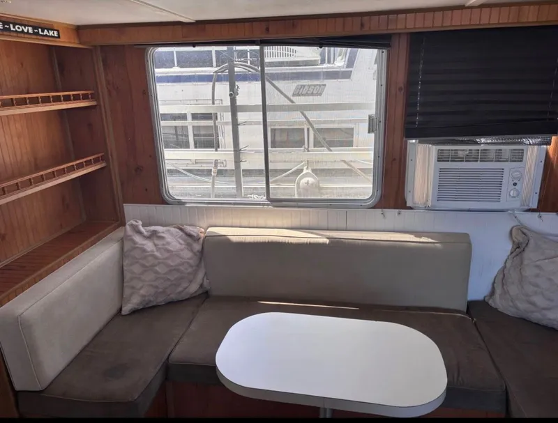 Slide: The Image of Interior of a 1992 Gibson Sport boat with sofa and window. - 4