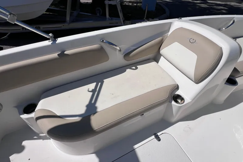 Slide: The Image of 2017 Stingray 182 SC boat interior with beige seating and cup holders. - 14