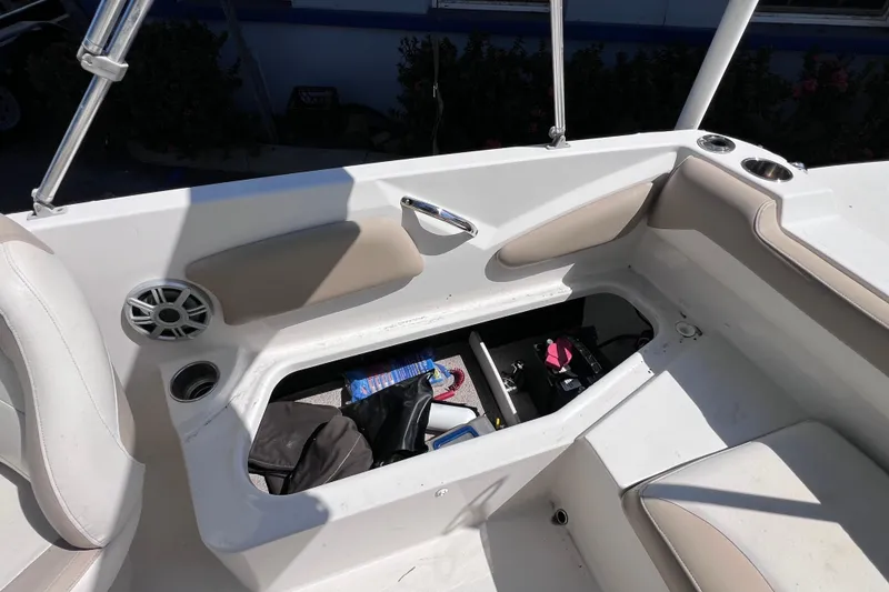 Slide: The Image of 2017 Stingray 182 SC boat interior with open storage compartment and speaker. - 16