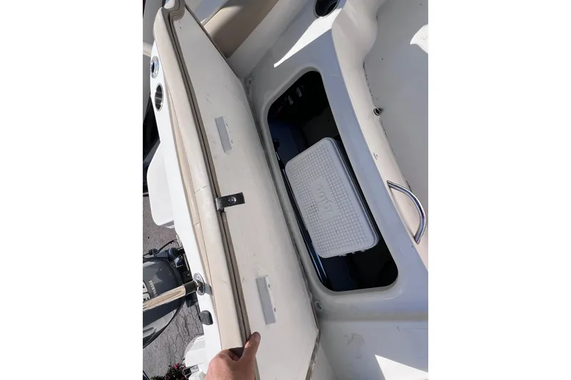 Slide: The Image of 2017 Stingray 182 SC boat storage compartment with Igloo cooler inside. - 17