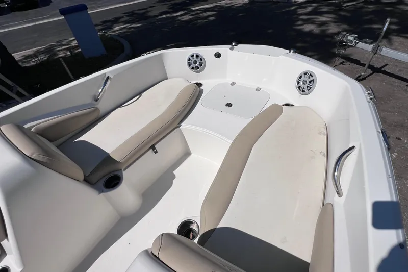 Slide: The Image of 2017 Stingray 182 SC boat interior with beige seating and cup holders. - 19