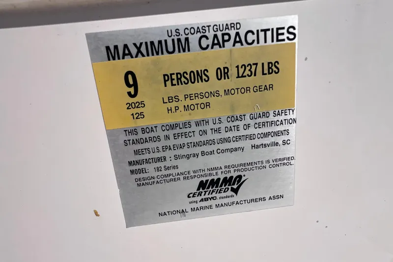 Slide: The Image of 2017 Stingray 182 SC boat capacity label, 9 persons or 1237 lbs, U.S. Coast Guard certified. - 20
